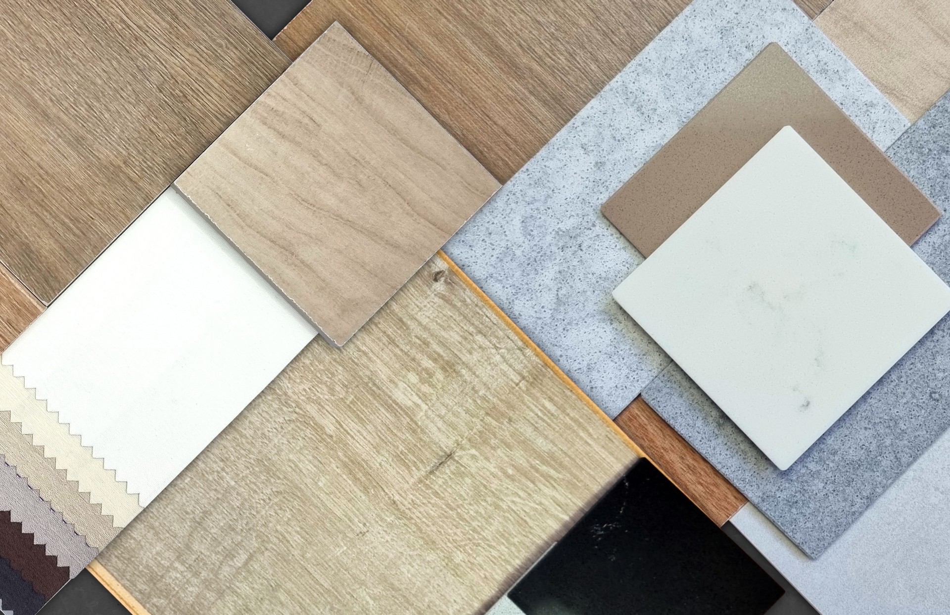 palette of interior material samples including wooden ceramic tiles, wood laminate flooring tile, solid acrylics, drapery fabric, stone tiles, artificial stones.